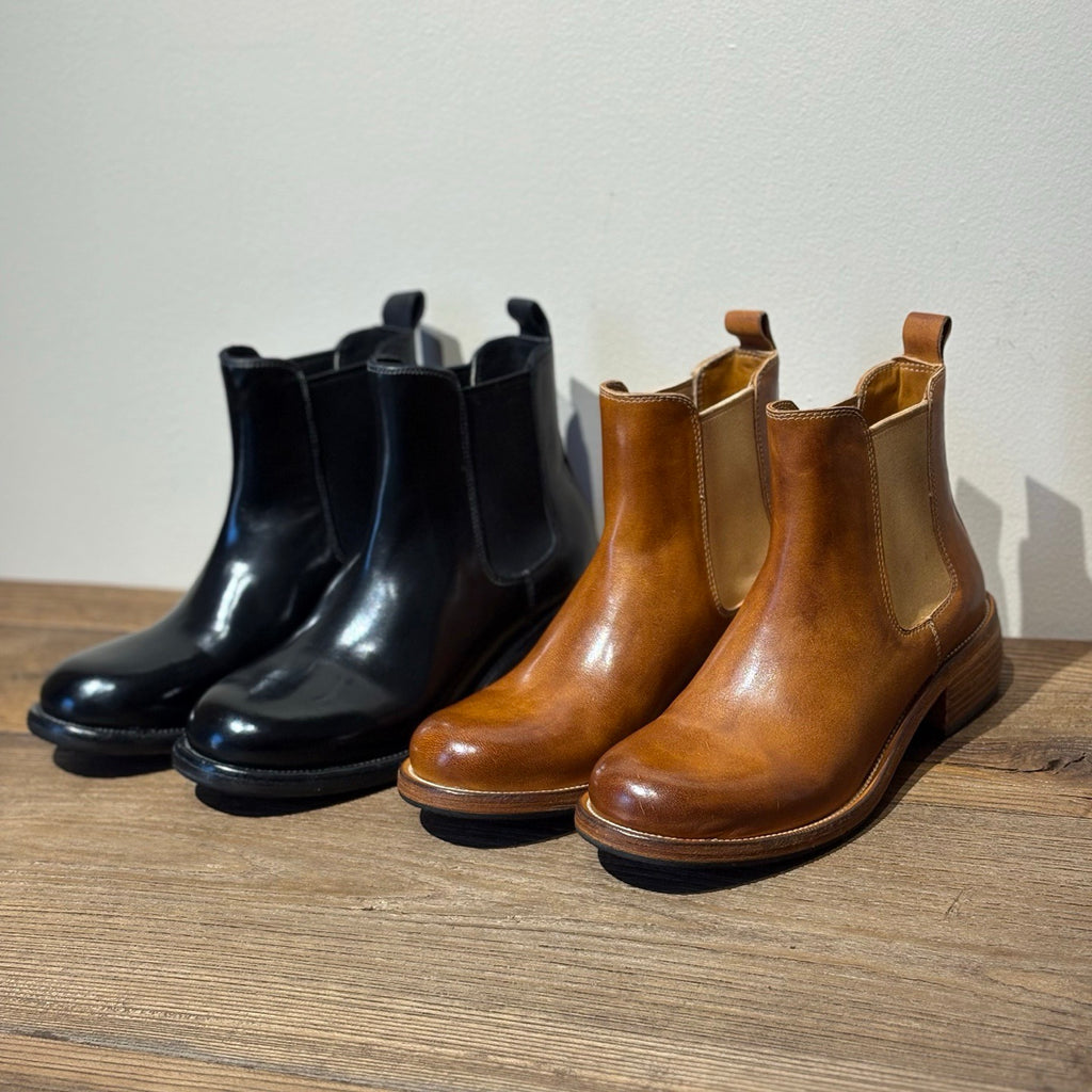 Rear view showing stacked heel and leather pull tab