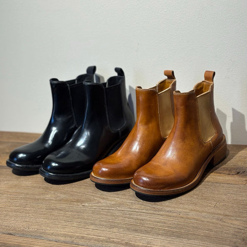 Rear view showing stacked heel and leather pull tab